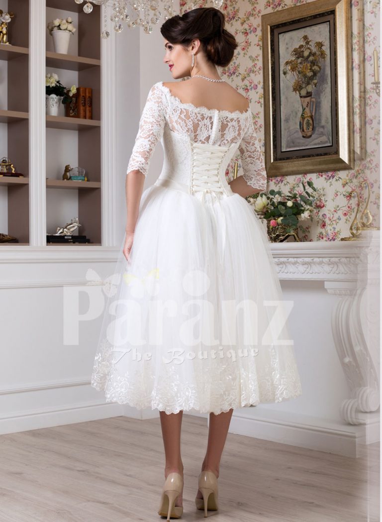 Women’s tea length white lacy bodice and tulle skirt wedding gown